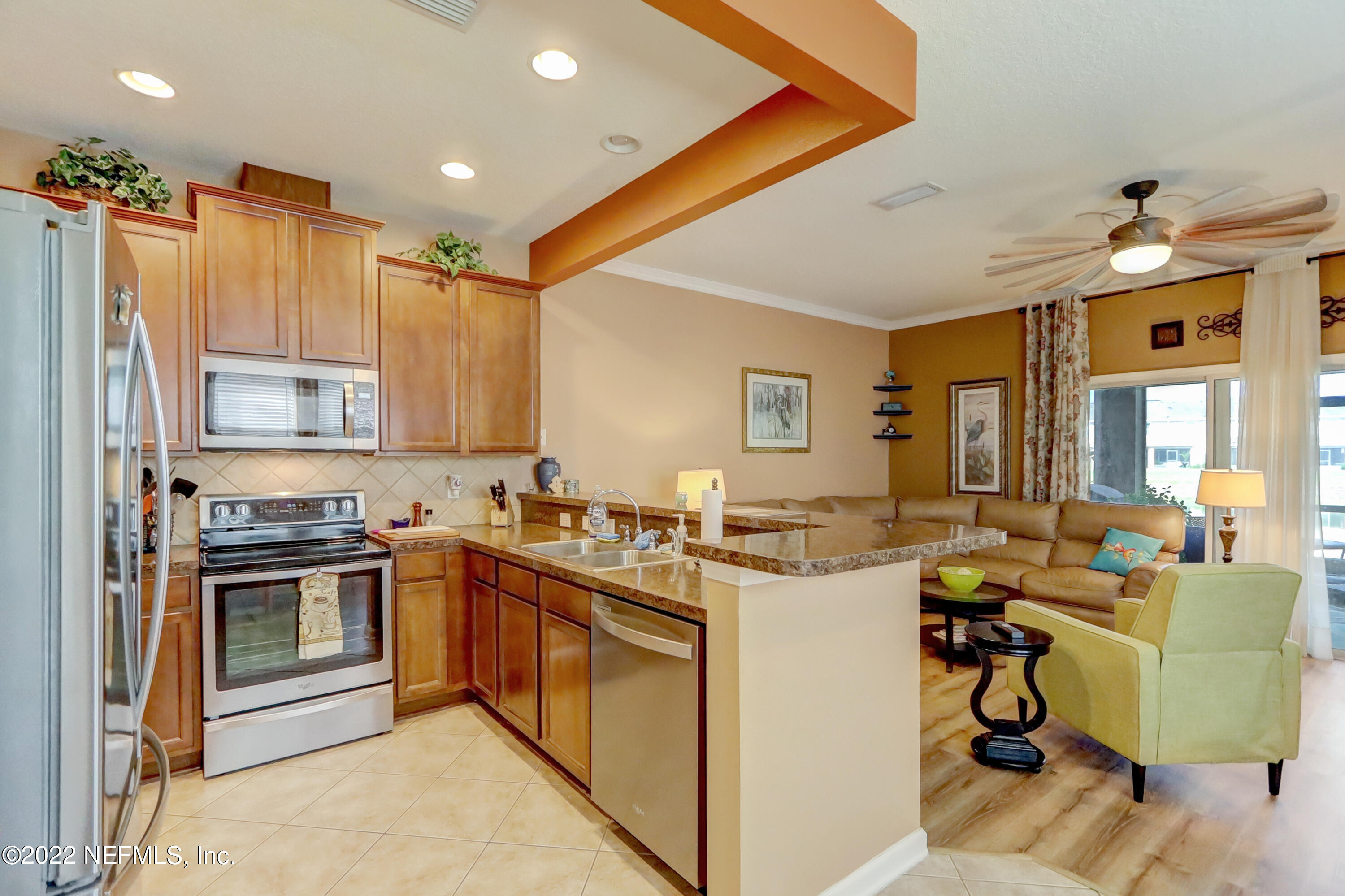12952 Spring Rain Road Jacksonville, FL 32258 - Photo 11 of 28 a kitchen with a stove a sink and a refrigerator