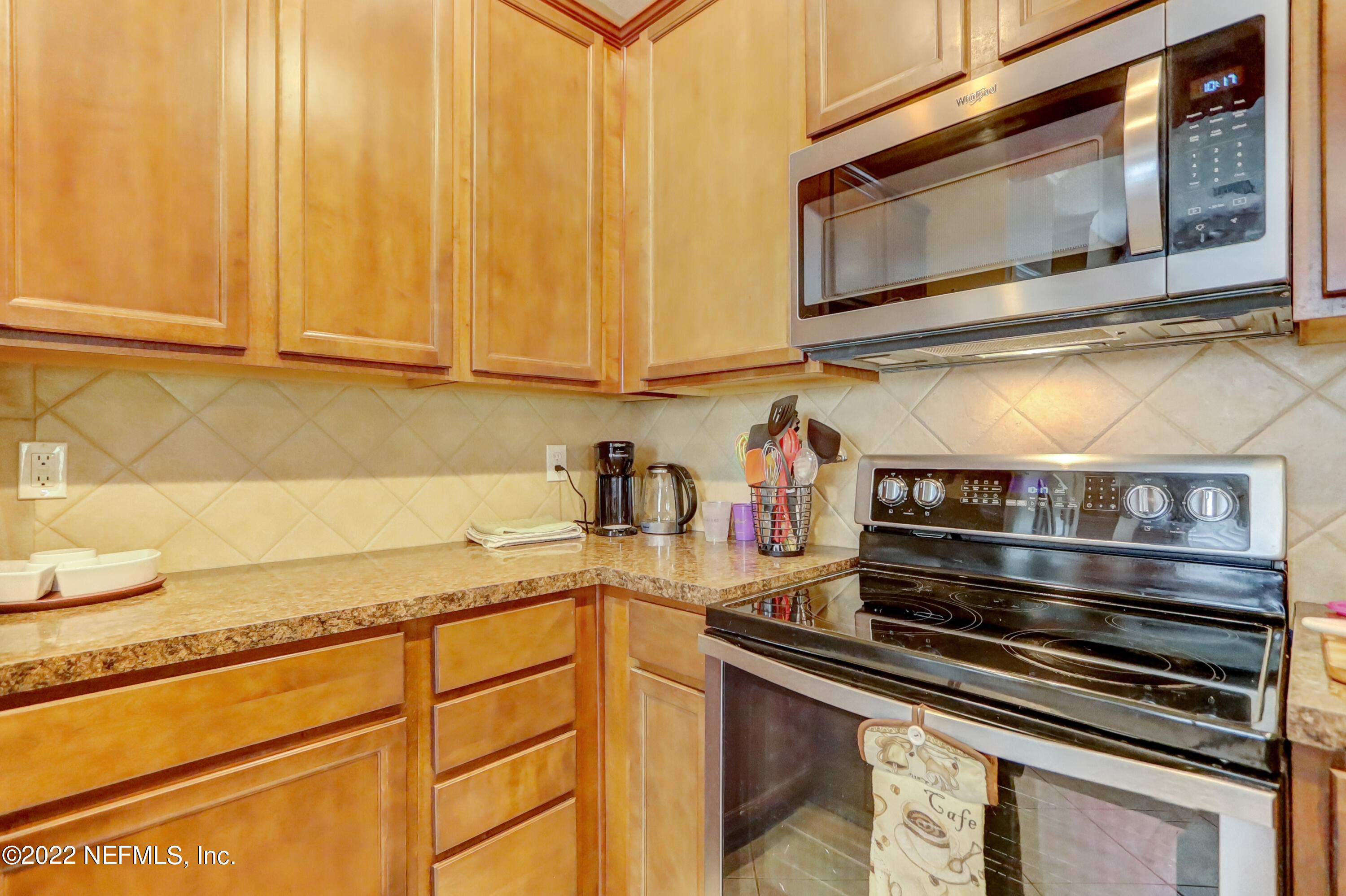12952 Spring Rain Road Jacksonville, FL 32258 - Photo 13 of 28 a kitchen with stainless steel appliances granite countertop a sink and cabinets