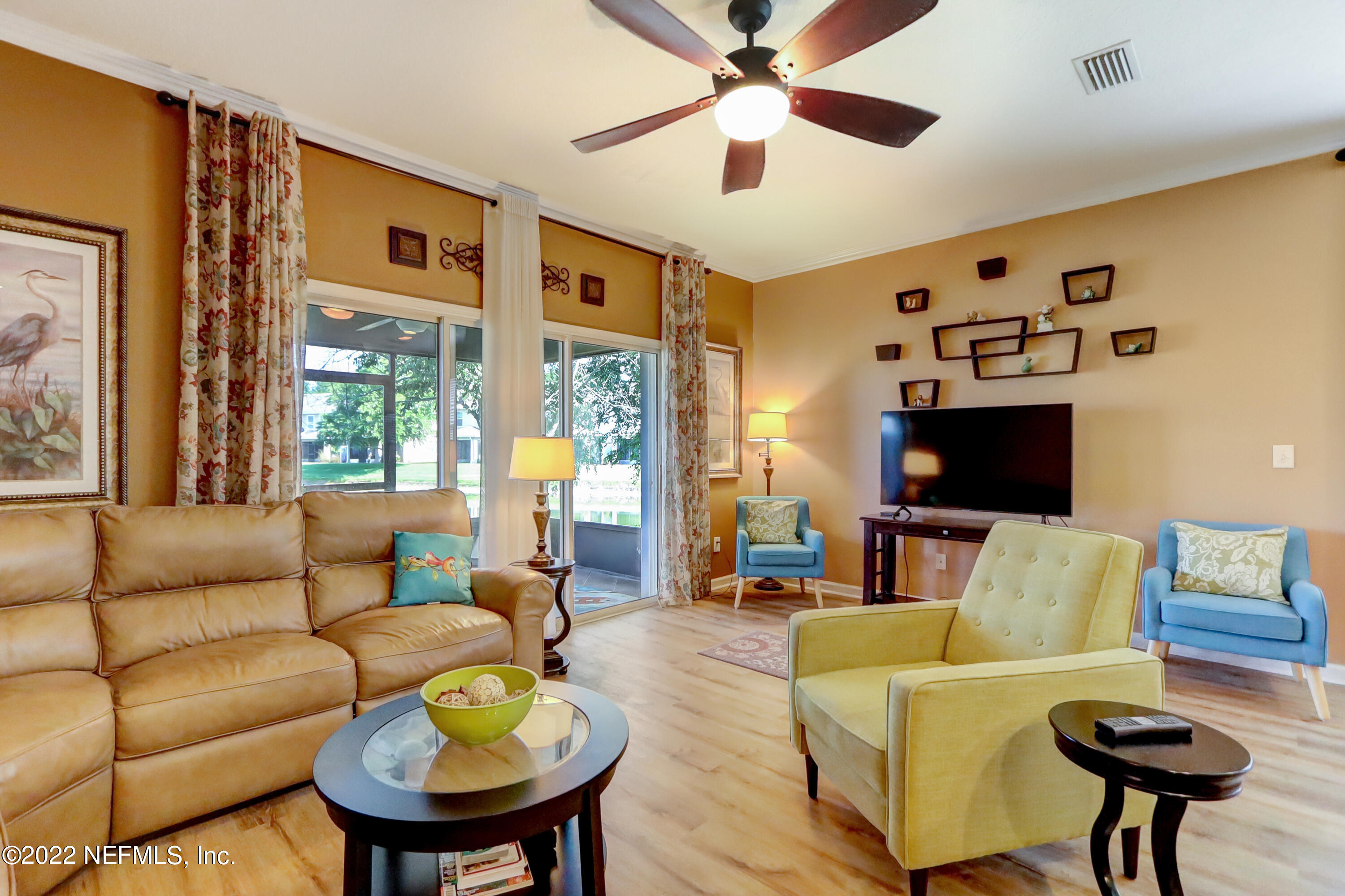12952 Spring Rain Road Jacksonville, FL 32258 - Photo 16 of 28 a living room with furniture and a flat screen tv