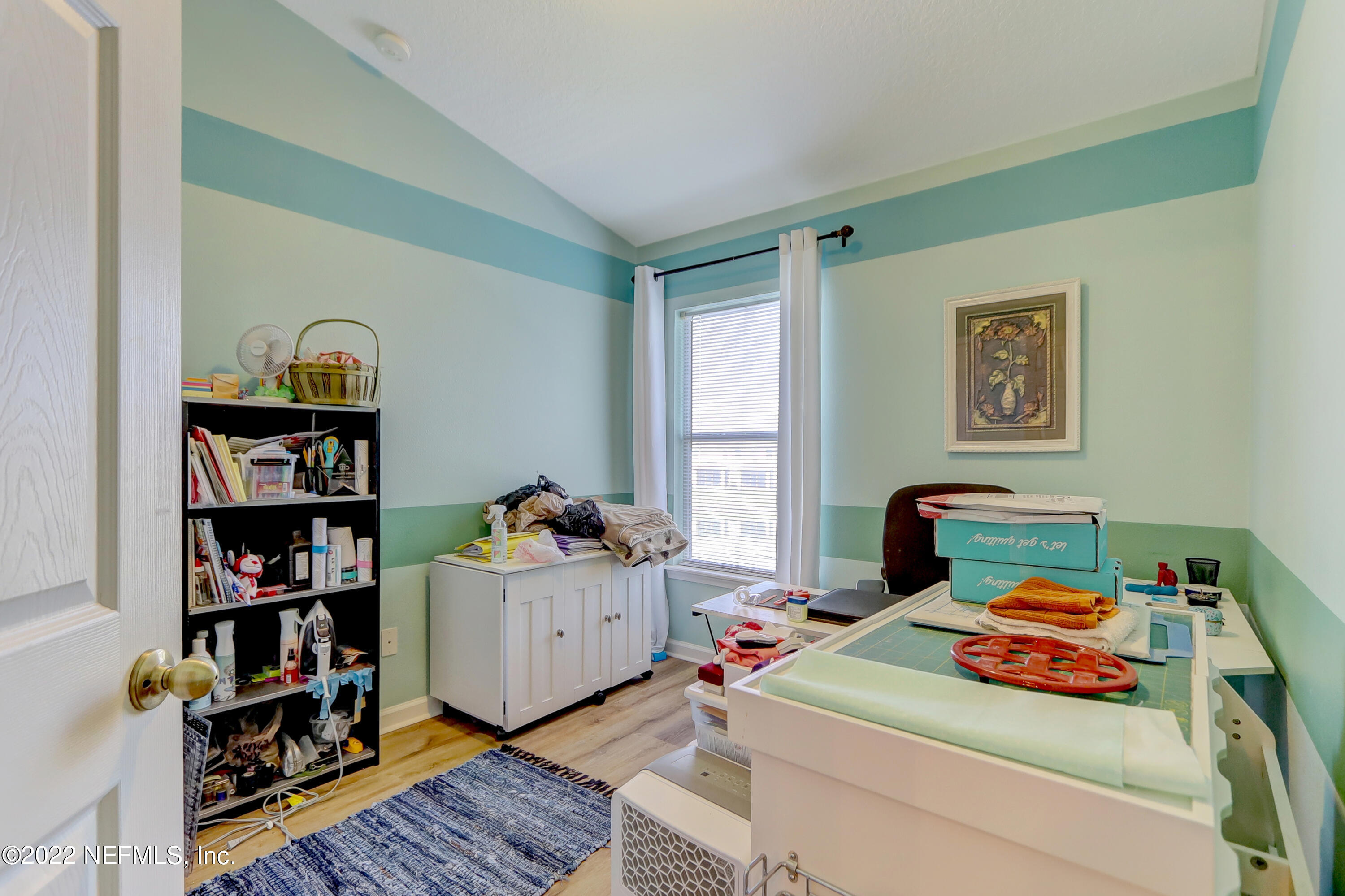 12952 Spring Rain Road Jacksonville, FL 32258 - Photo 18 of 28 a bedroom with furniture and a book shelf