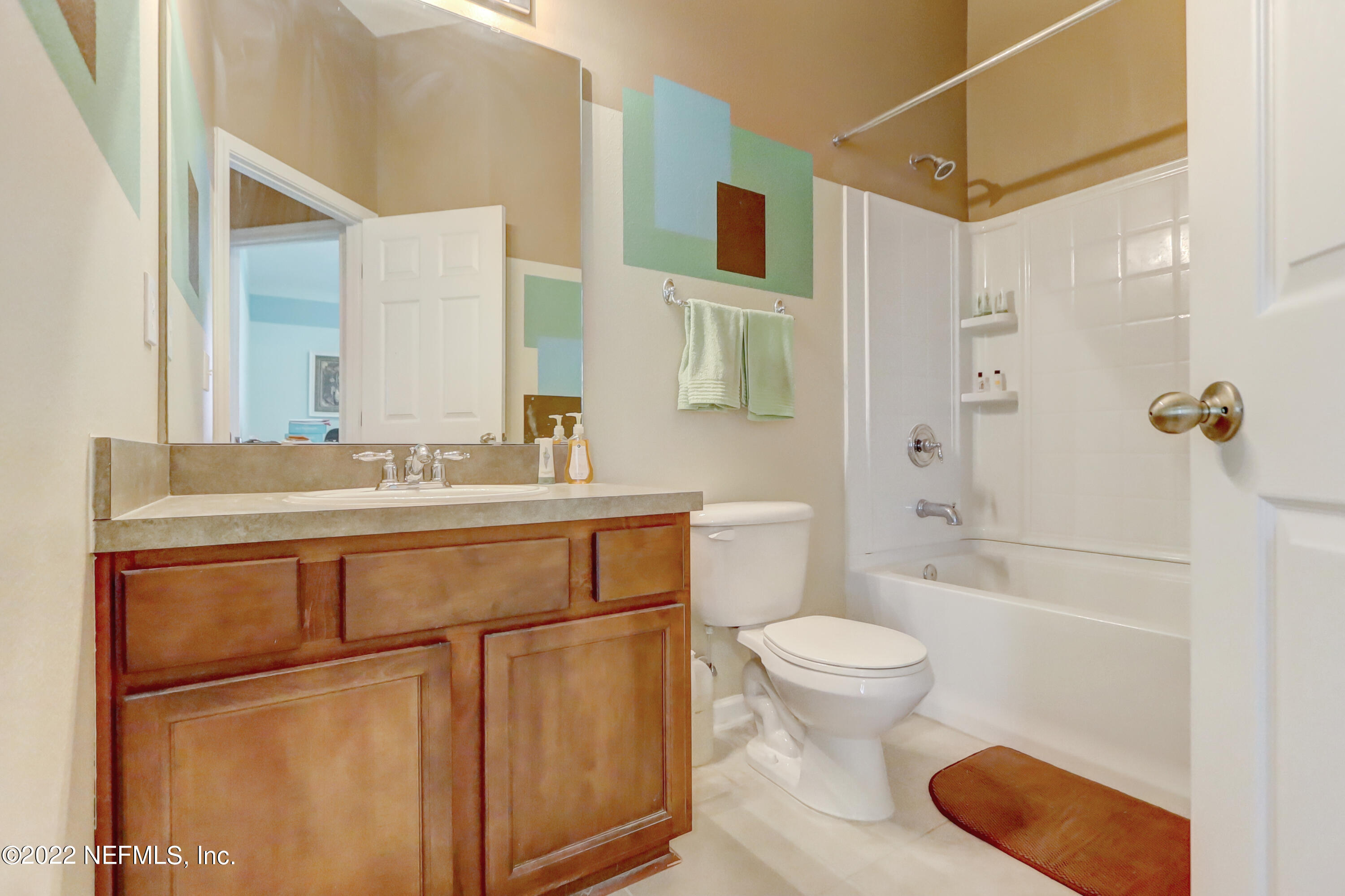 12952 Spring Rain Road Jacksonville, FL 32258 - Photo 21 of 28 a bathroom with a sink toilet vanity and shower