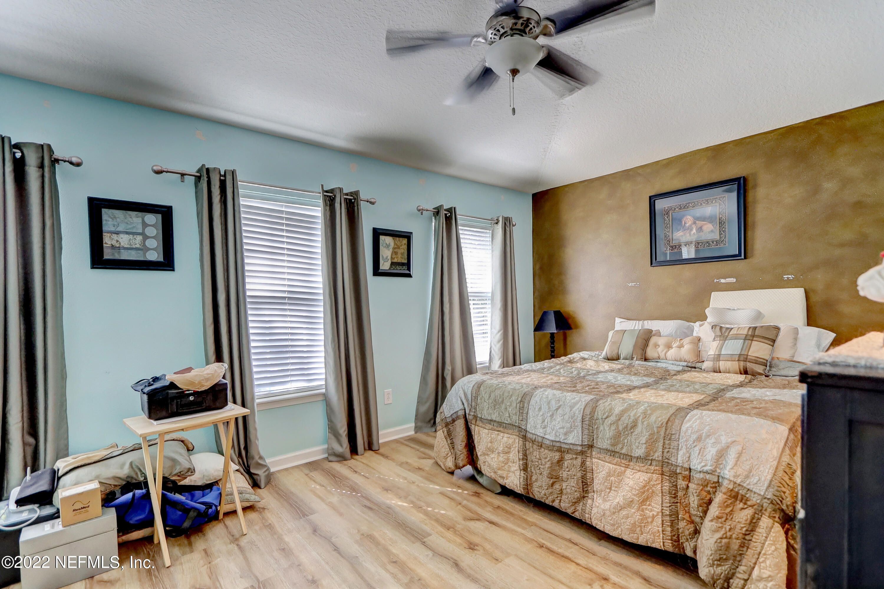 12952 Spring Rain Road Jacksonville, FL 32258 - Photo 22 of 28 a bedroom with a bed and a chandelier