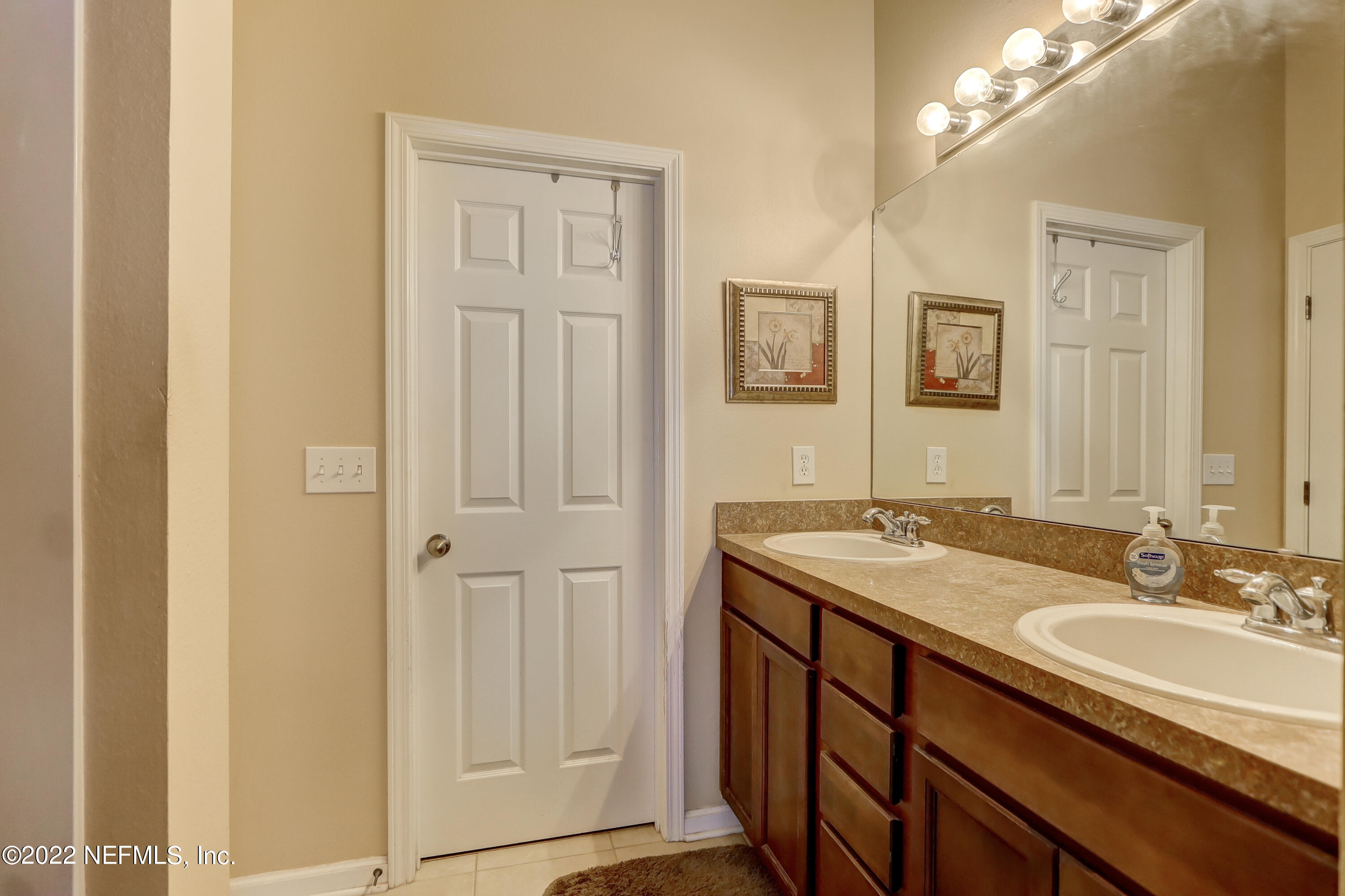 12952 Spring Rain Road Jacksonville, FL 32258 - Photo 24 of 28 a bathroom with a granite countertop sink and a mirror