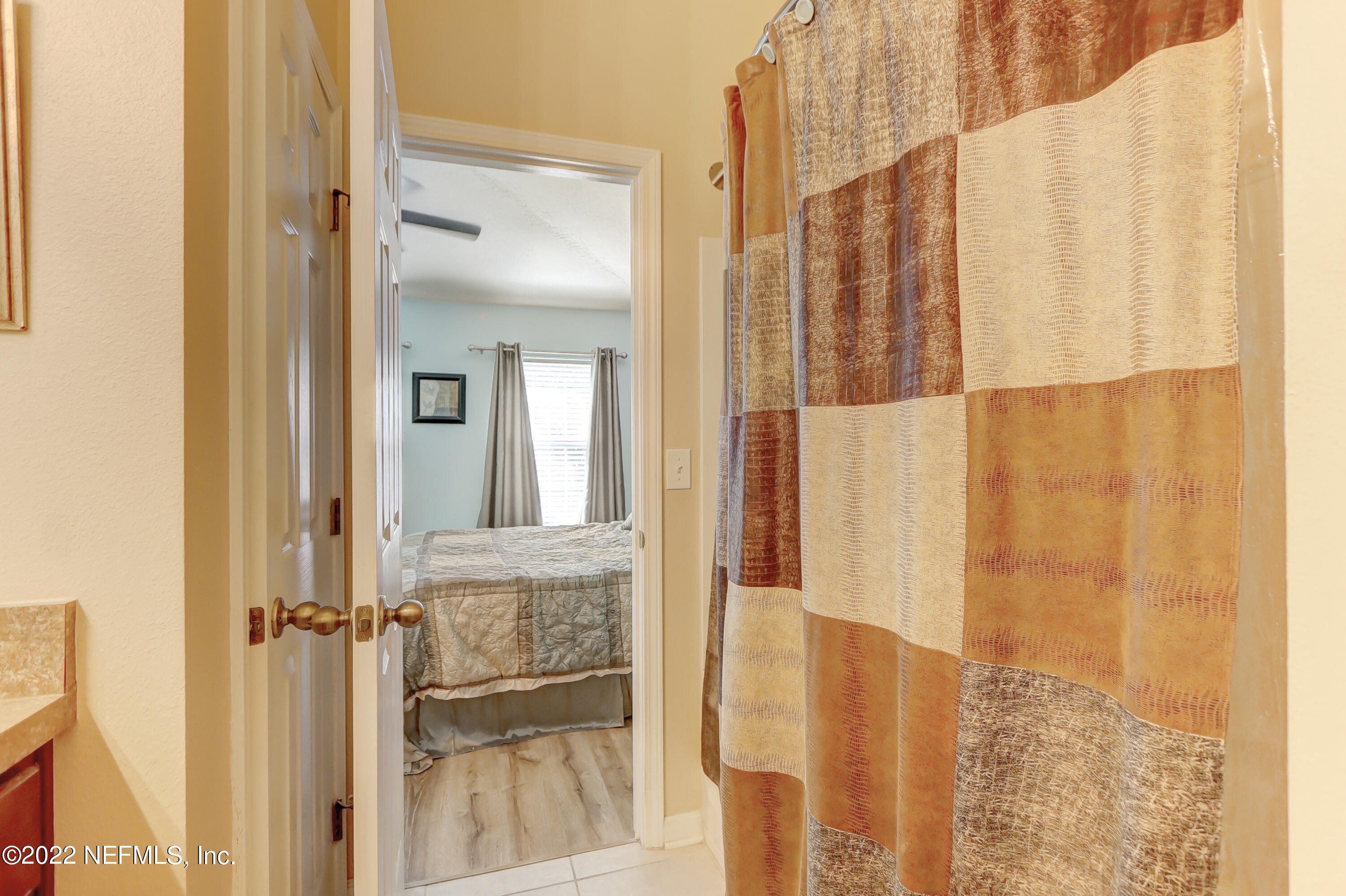 12952 Spring Rain Road Jacksonville, FL 32258 - Photo 25 of 28 a view of a bathroom with a shower curtain