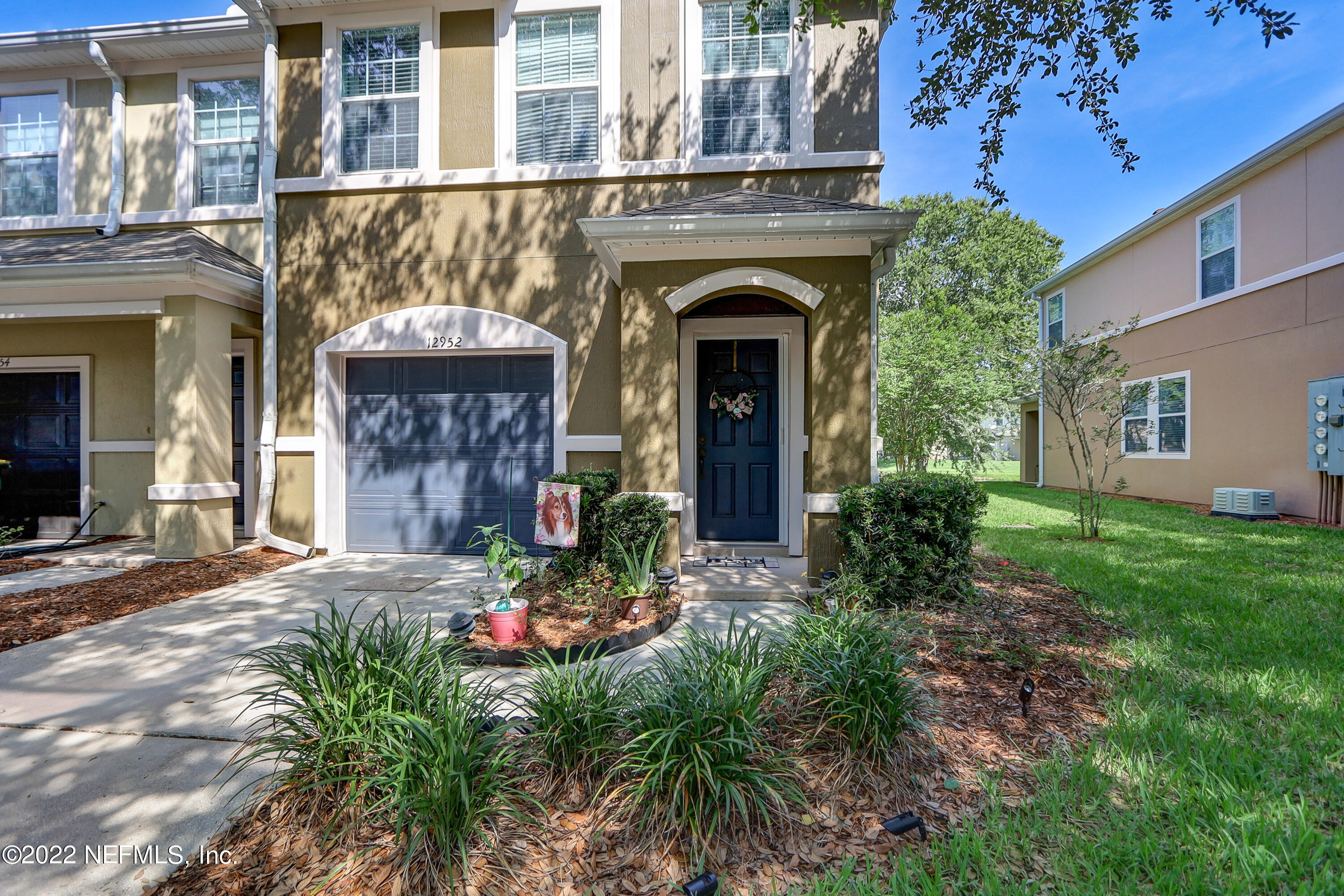 12952 Spring Rain Road Jacksonville, FL 32258 - Photo 3 of 28 a front view of a house with plants