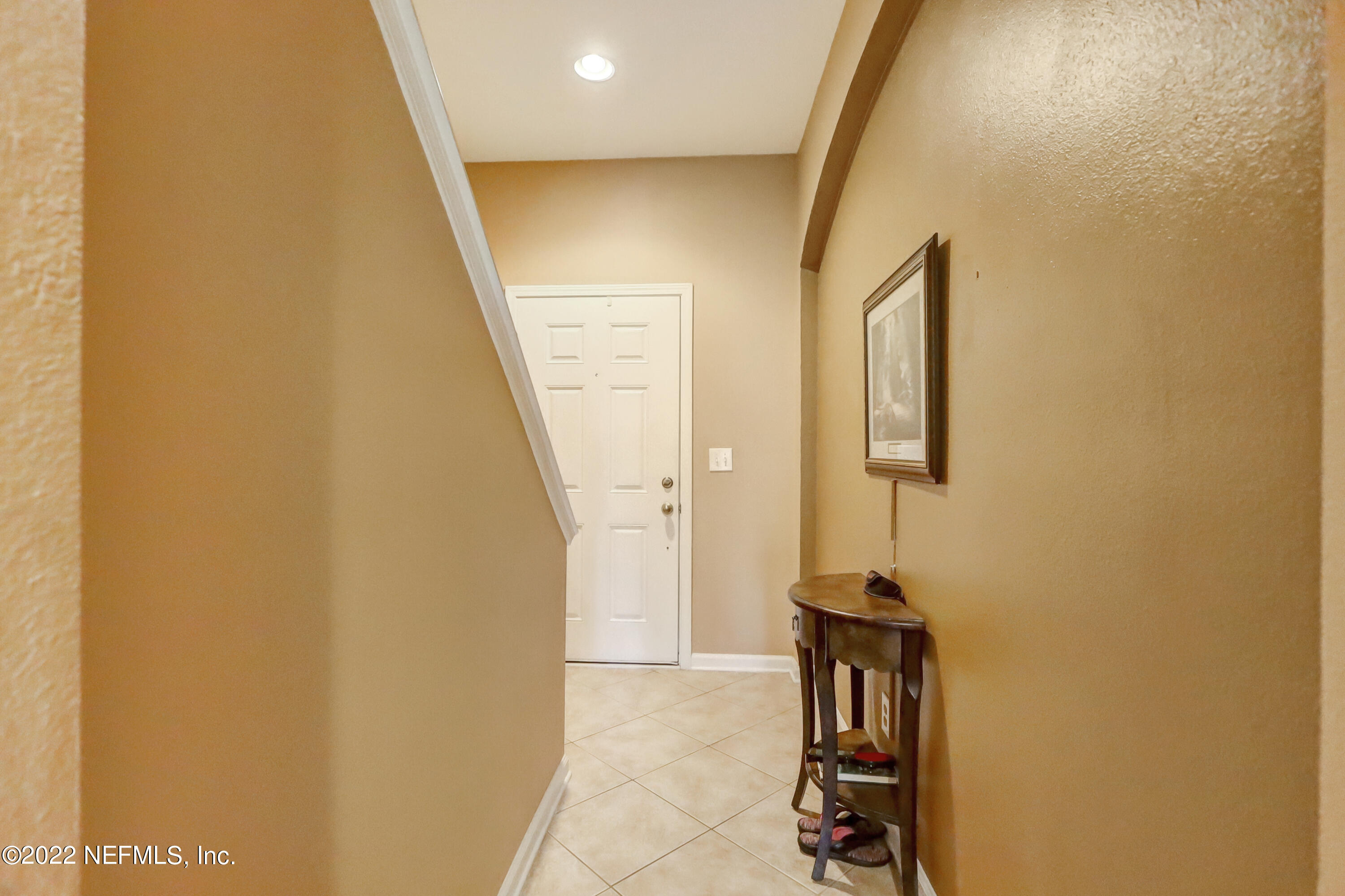 12952 Spring Rain Road Jacksonville, FL 32258 - Photo 6 of 28 a view of a hallway with wooden floor and staircase