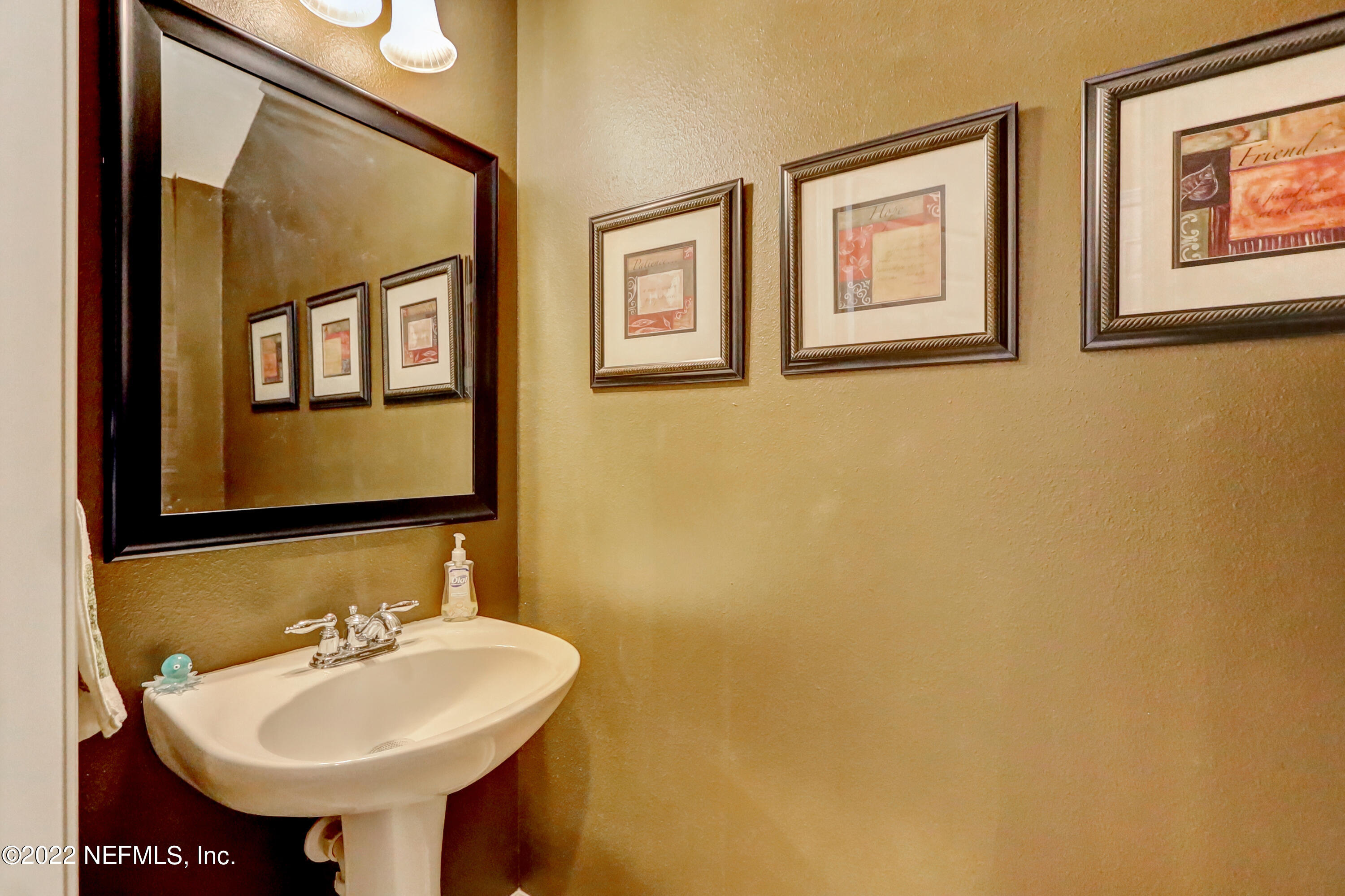 12952 Spring Rain Road Jacksonville, FL 32258 - Photo 8 of 28 a bathroom with a sink and a mirror