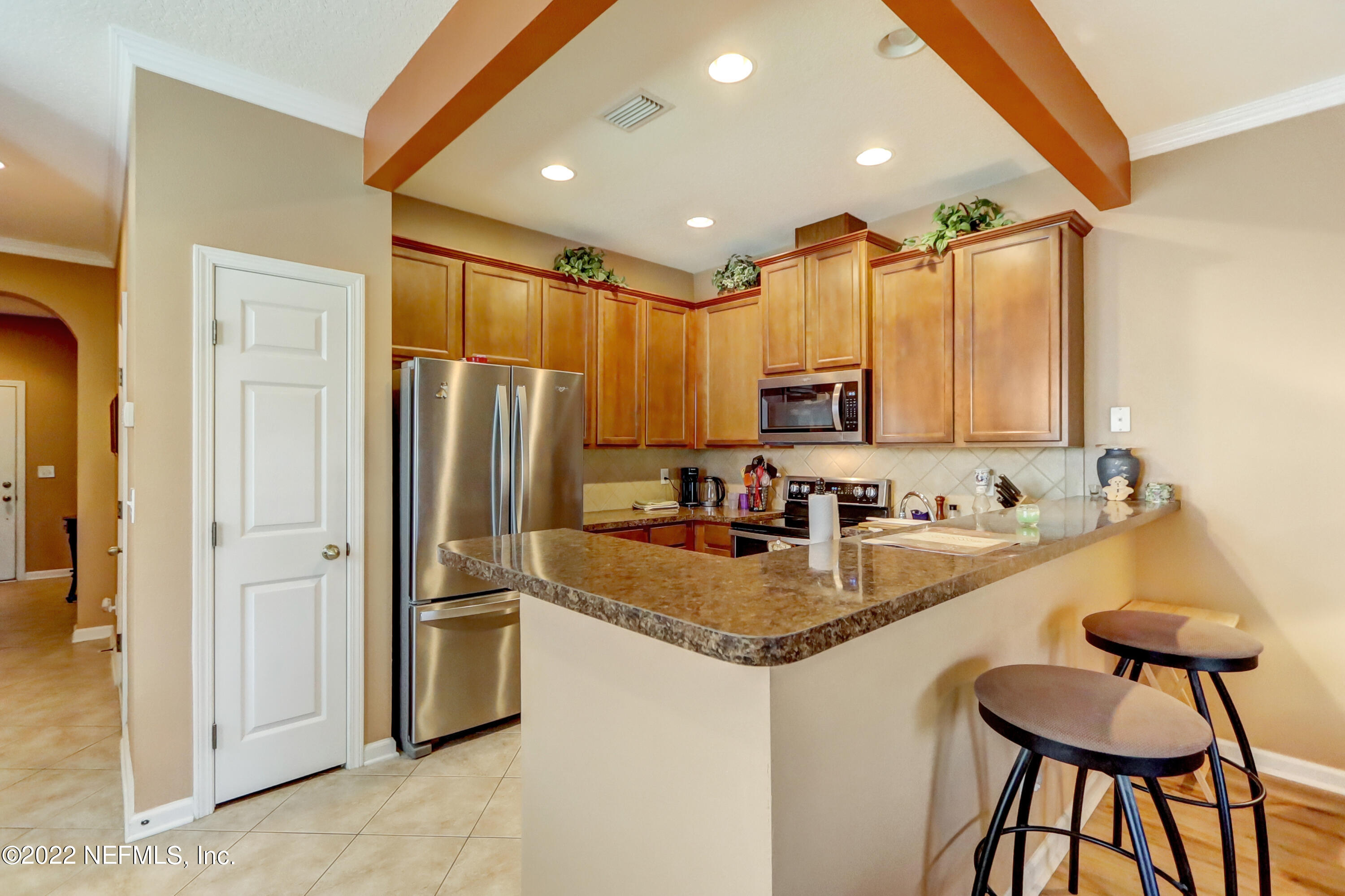 12952 Spring Rain Road Jacksonville, FL 32258 - Photo 10 of 28 a kitchen with stainless steel appliances granite countertop a refrigerator a sink and white cabinets
