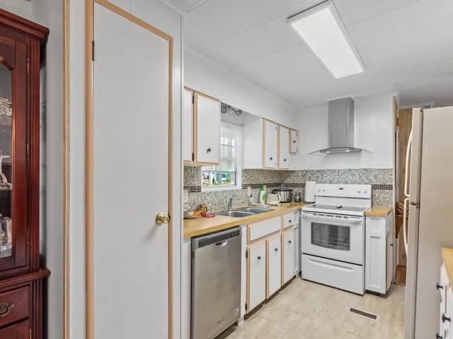 a kitchen with a stove top oven sink and cabinets