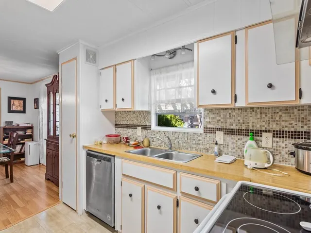 a kitchen with a sink stove and cabinets