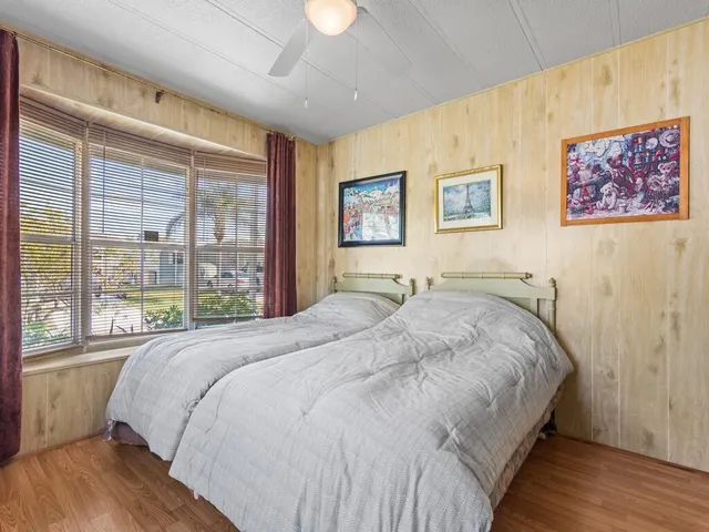 a large bed sitting in a bedroom next to a window