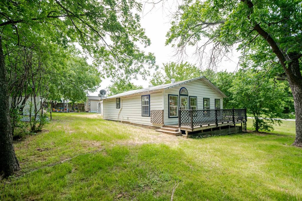 199 B.C. Rhome Avenue Rhome, TX 76078 - Photo 2 of 34 a front view of house with yard and green space