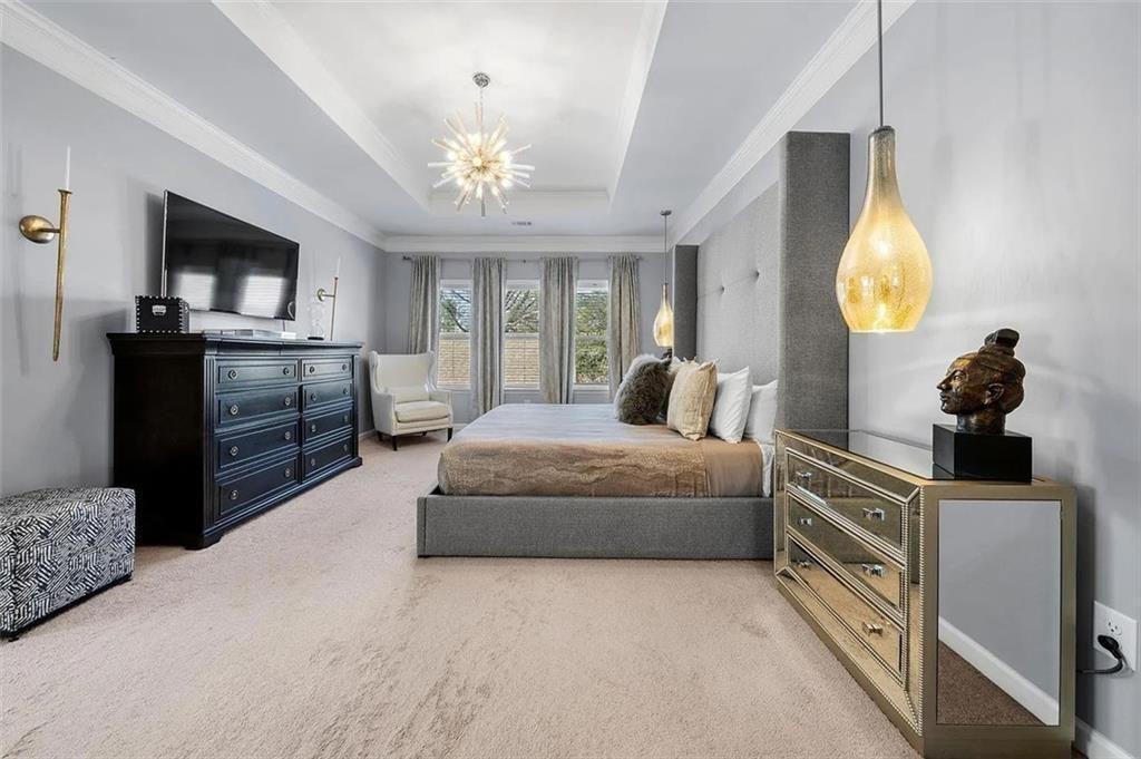 3165 Oakdale Road Atlanta, GA 30354 - Photo 21 of 35 a bedroom with a bed and a chandelier