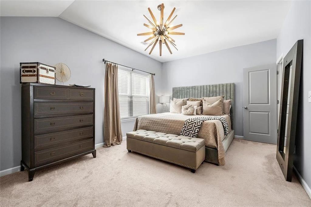 3165 Oakdale Road Atlanta, GA 30354 - Photo 29 of 35 a bedroom with a bed and a chandelier