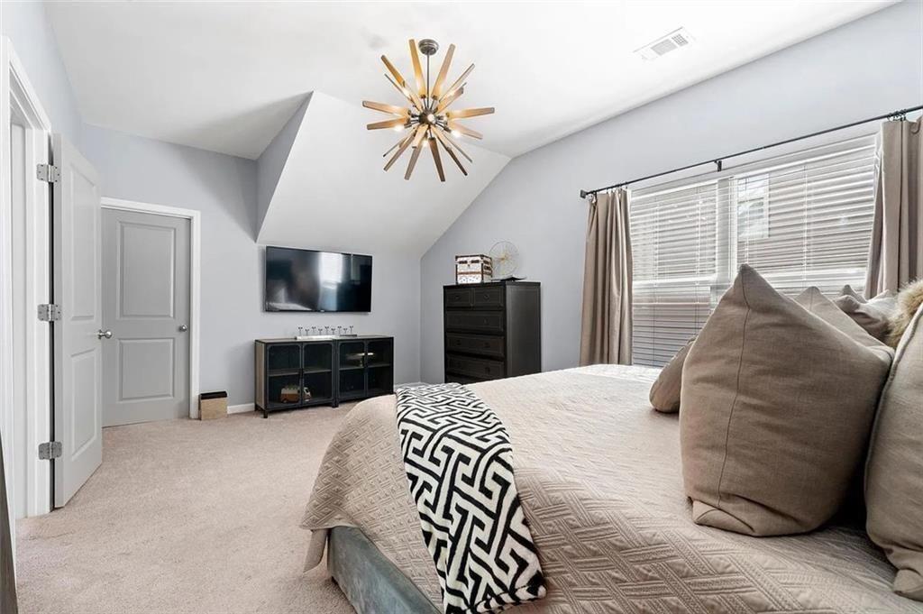3165 Oakdale Road Atlanta, GA 30354 - Photo 30 of 35 a spacious bedroom with a bed and a flat screen television