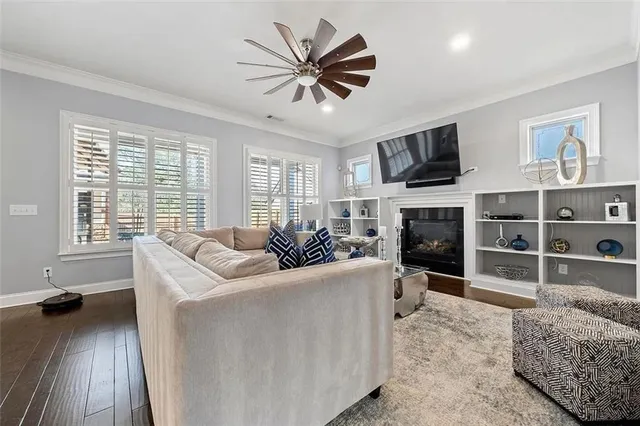 a living room with furniture a fireplace and a flat screen tv