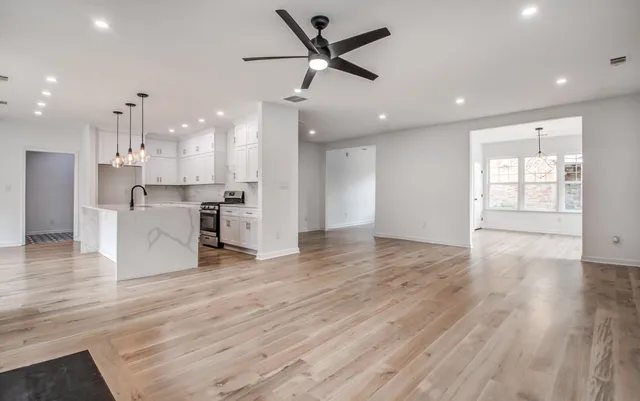 a view of a kitchen with a stove cabinets and wooden floor