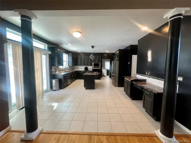 a kitchen with stainless steel appliances kitchen island granite countertop a sink and cabinets
