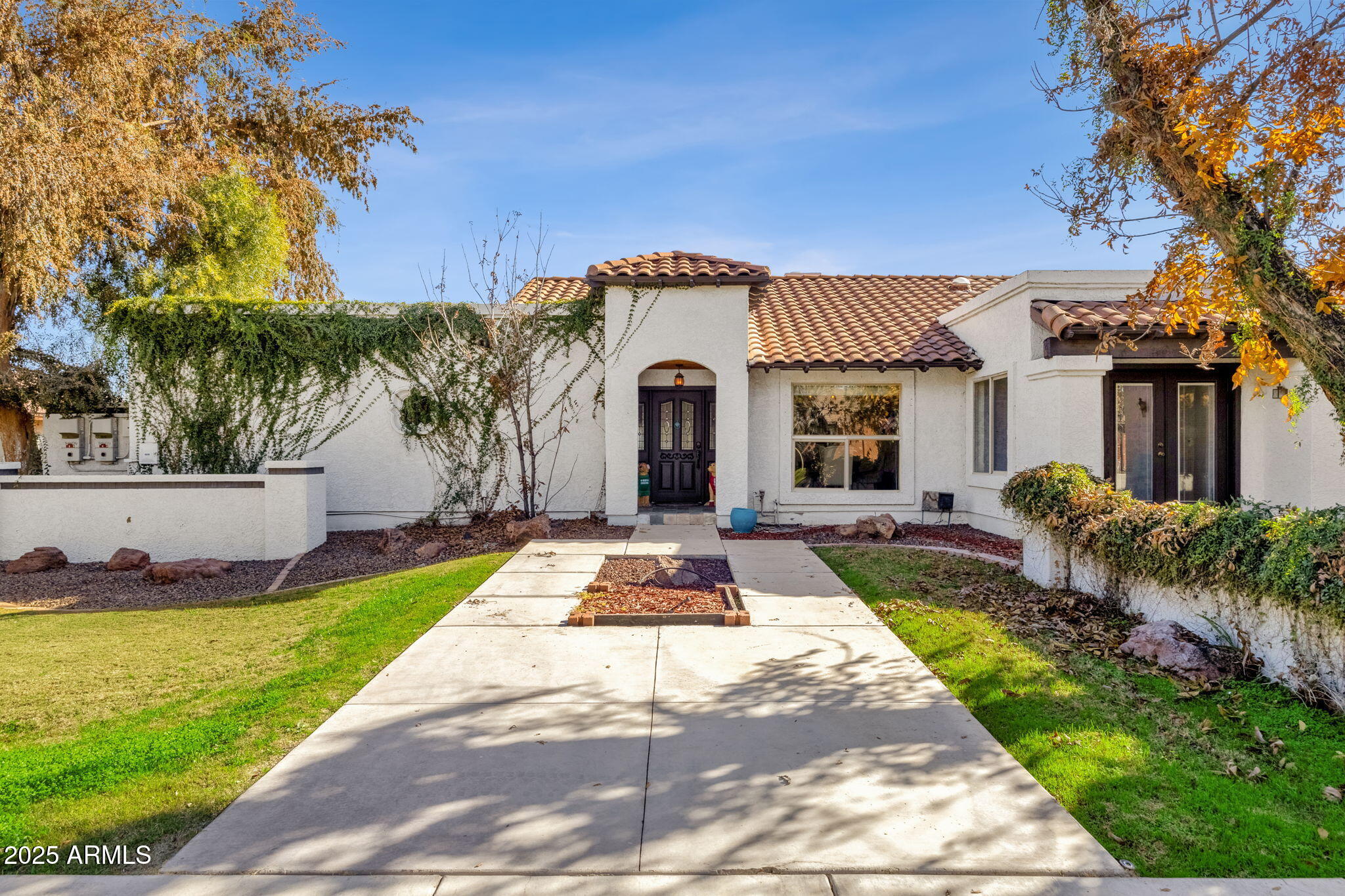 89 North Riata Street Gilbert, AZ 85234 - Photo 1 of 40 a front view of a house with yard and green space