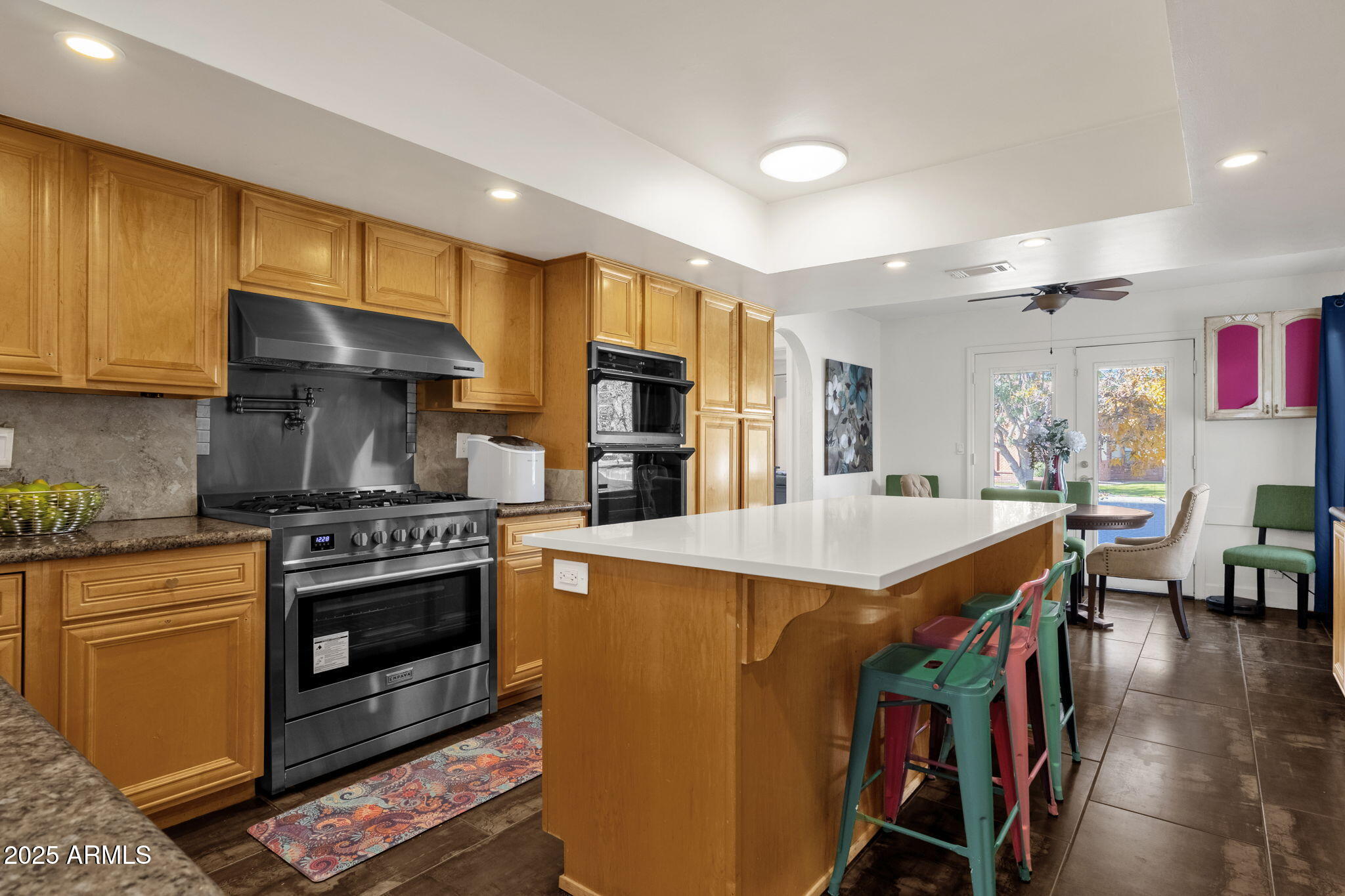 89 North Riata Street Gilbert, AZ 85234 - Photo 14 of 40 a kitchen with stainless steel appliances granite countertop a stove and a refrigerator