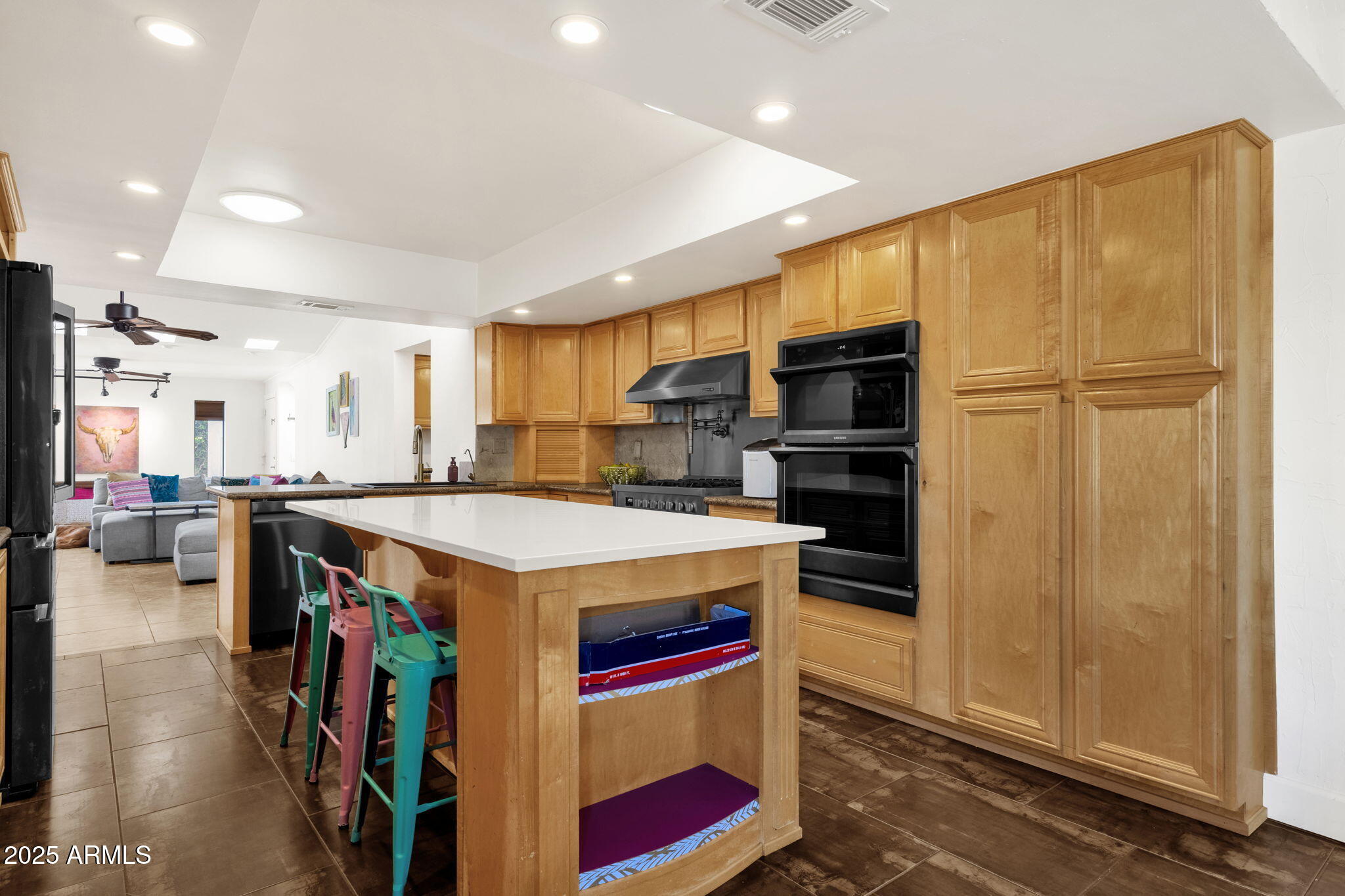 89 North Riata Street Gilbert, AZ 85234 - Photo 18 of 40 a kitchen with stainless steel appliances granite countertop a stove and a refrigerator