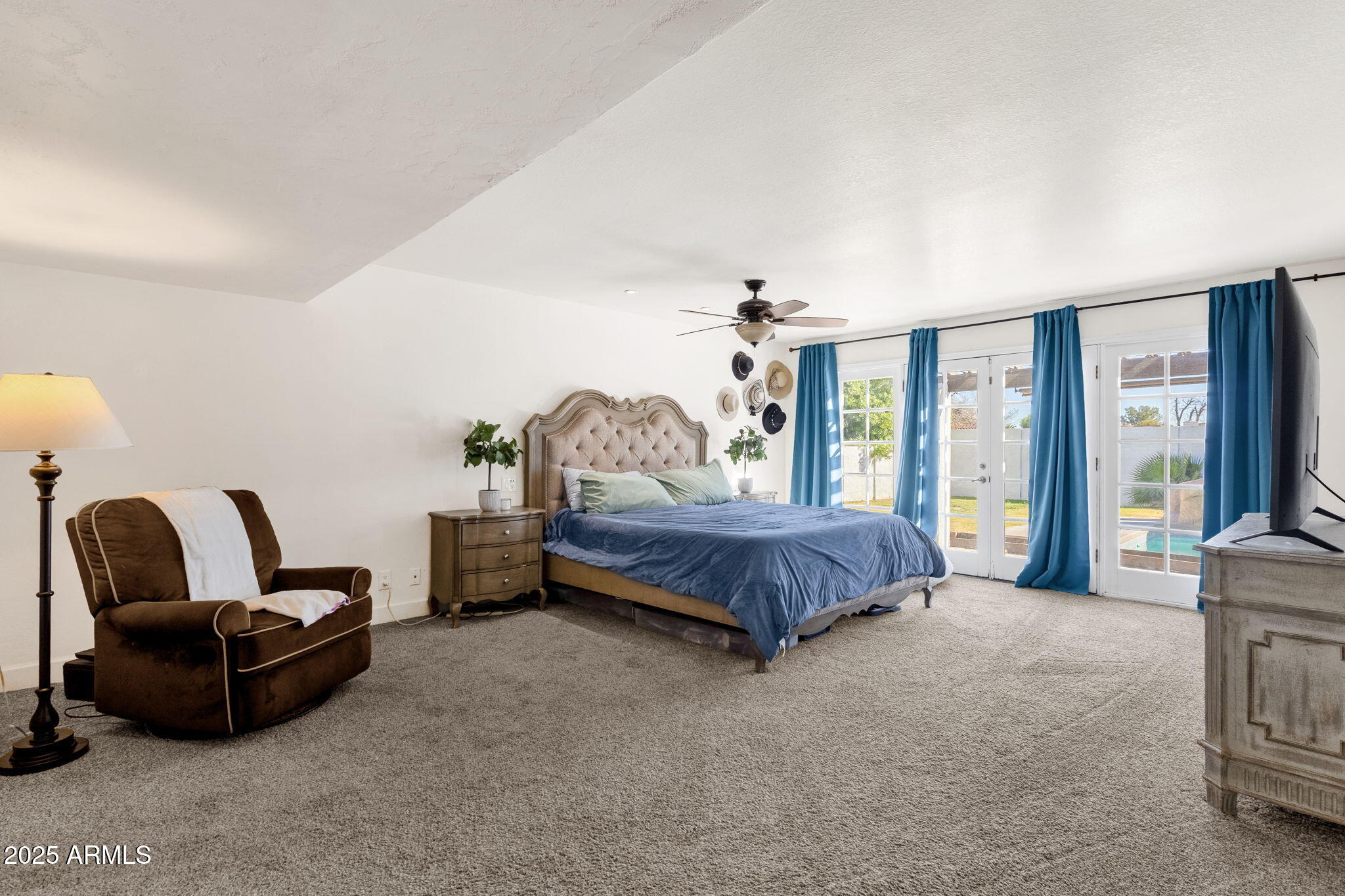 89 North Riata Street Gilbert, AZ 85234 - Photo 19 of 40 a bedroom with a bed chair and a large window