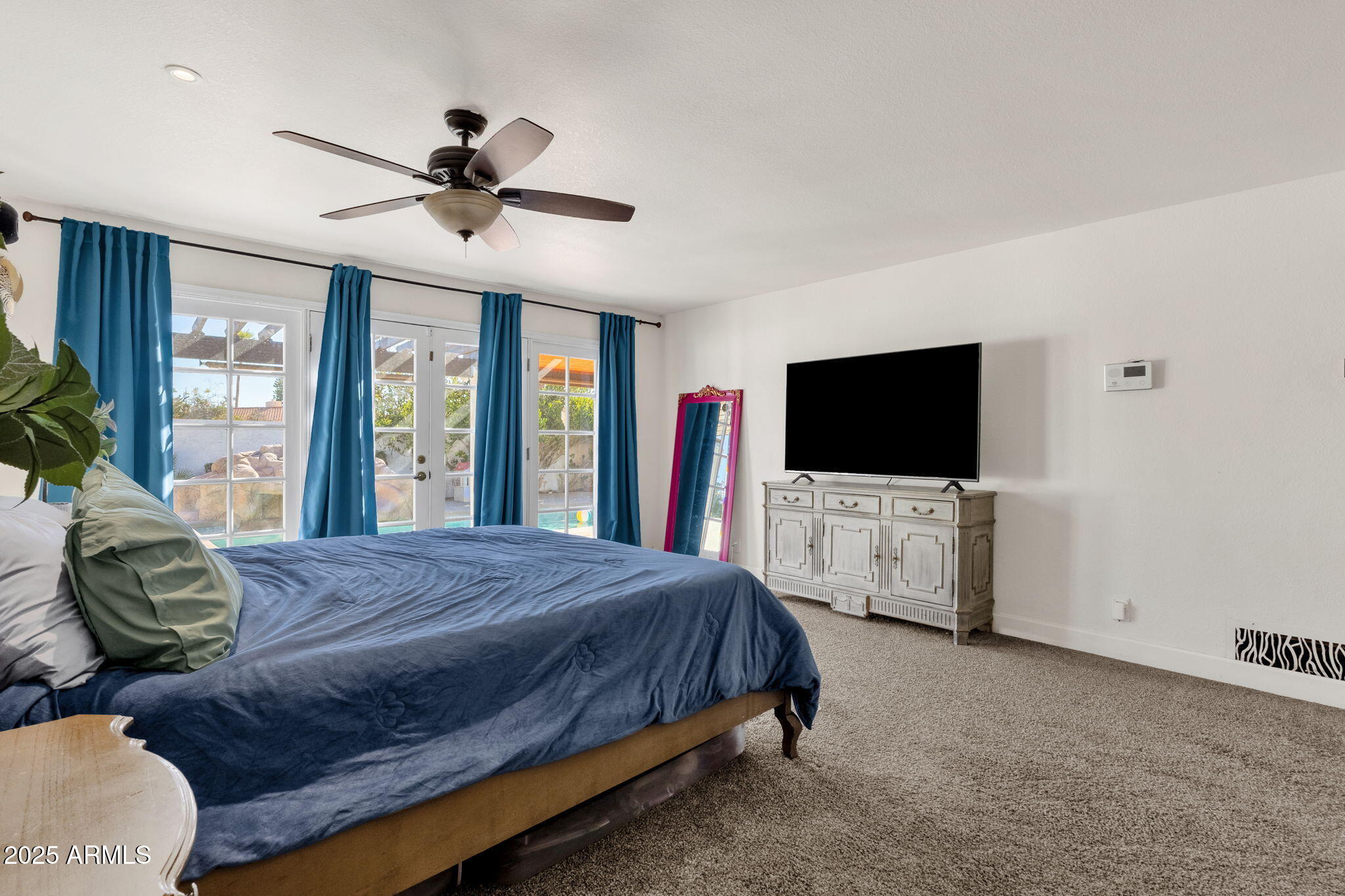 89 North Riata Street Gilbert, AZ 85234 - Photo 20 of 40 a bedroom with a bed and a flat screen tv