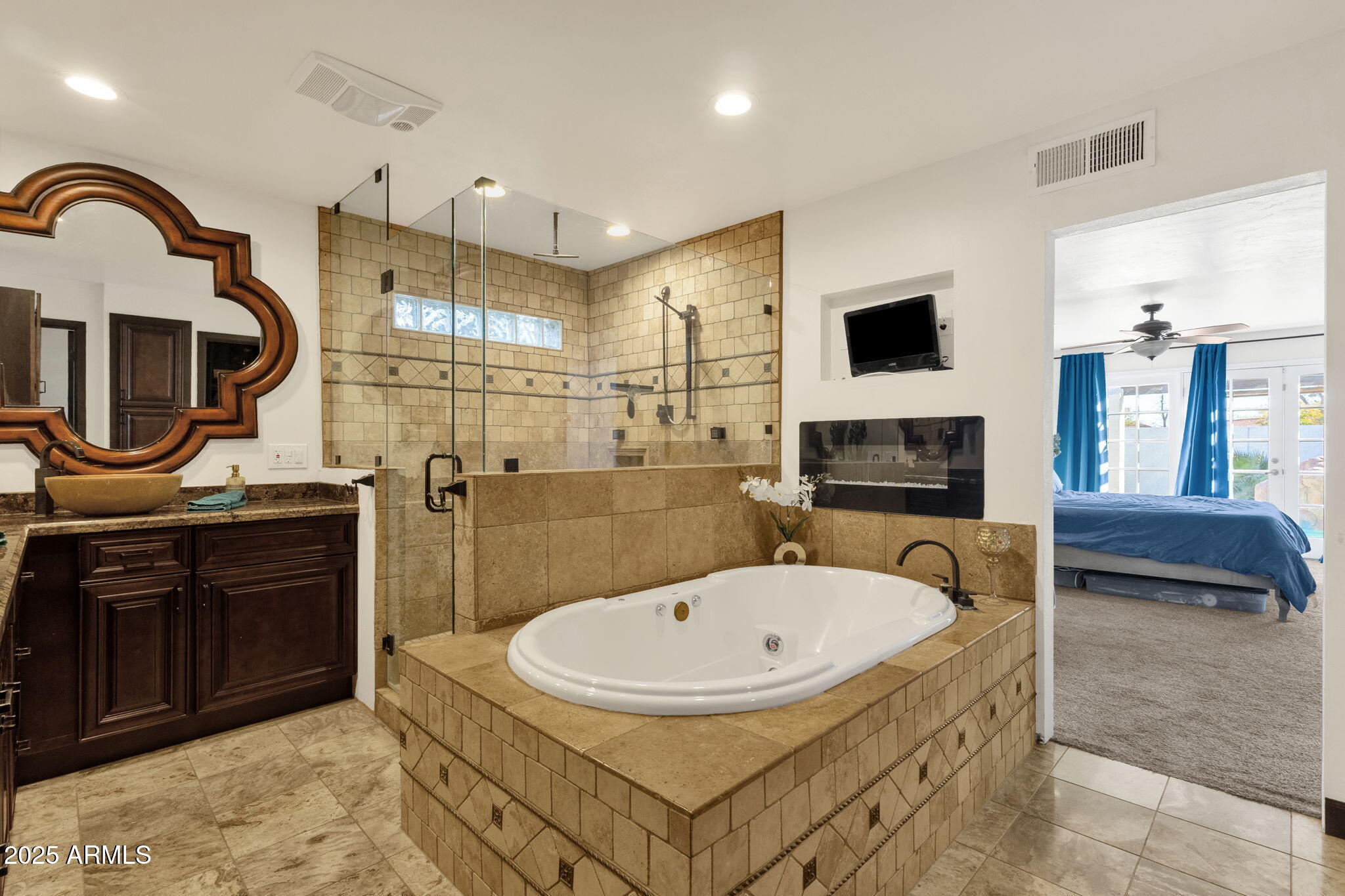 89 North Riata Street Gilbert, AZ 85234 - Photo 23 of 40 a bathroom with a sink a mirror and a shower