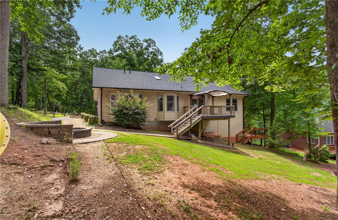 136 Loran Pointe Circle Seneca, SC 29672 - Photo 44 of 50 A tranquil backyard setting features a delightful fire pit, inviting outdoor relaxation.