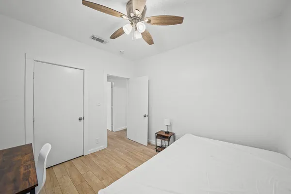 a bedroom with a bed and a chandelier