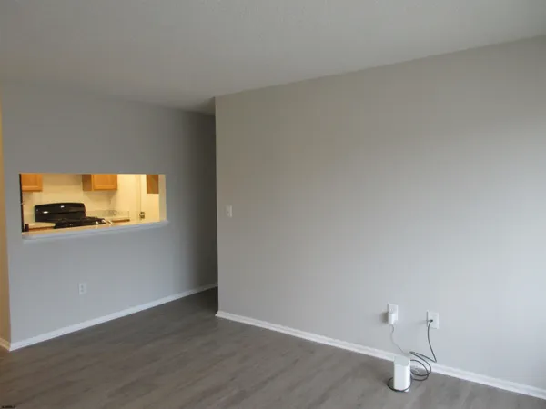 a view of an empty room and wooden floor