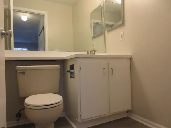 a bathroom with a toilet a sink and mirror