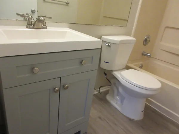 a white toilet sitting next to a bathroom sink