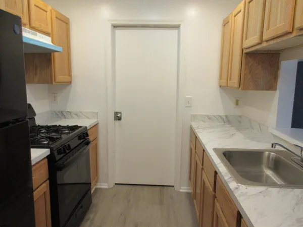 a kitchen with a sink stove and refrigerator