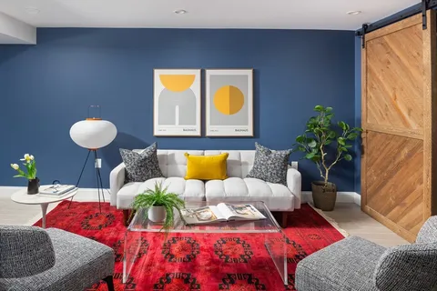 a living room with furniture and a potted plant