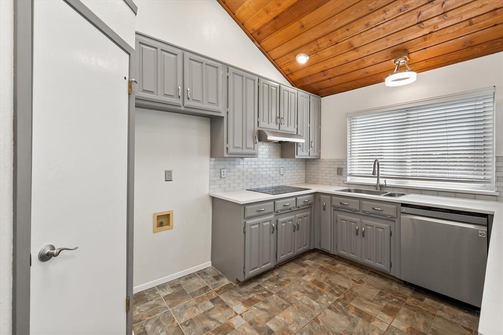 1036 Clinton Street Carrollton, TX 75007 - Photo 15 of 40 Kitchen featuring gray cabinets, lofted ceiling, stainless steel dishwasher, wood ceiling, and backsplash