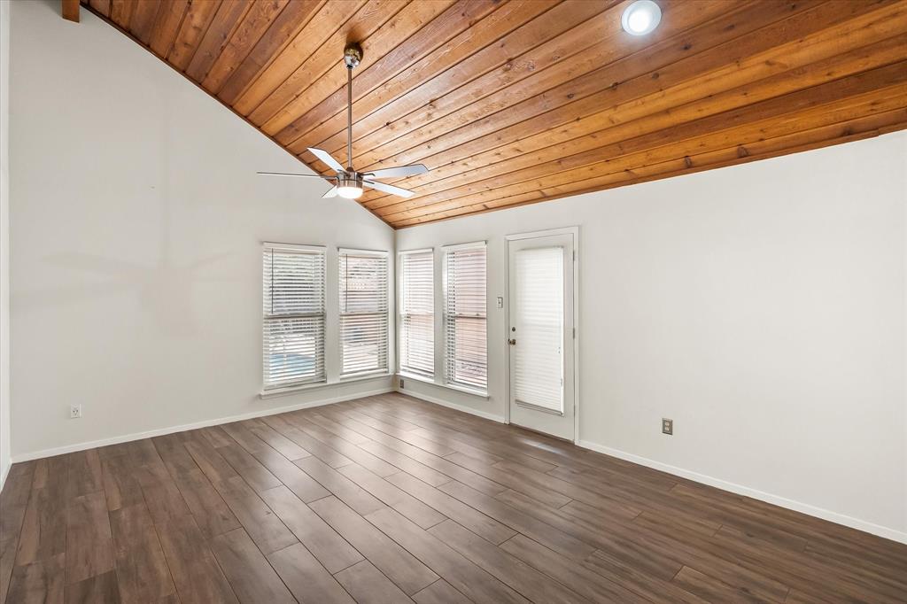 1036 Clinton Street Carrollton, TX 75007 - Photo 24 of 40 Unfurnished room featuring lofted ceiling, wood ceiling, dark wood-type flooring, and ceiling fan