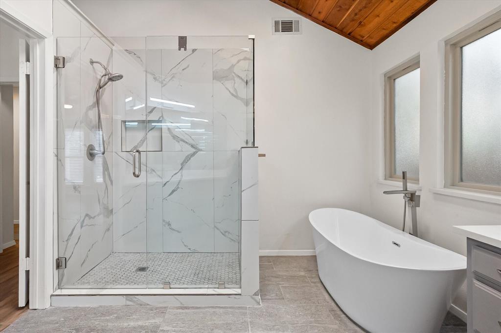 1036 Clinton Street Carrollton, TX 75007 - Photo 26 of 40 Full bath with a marble finish shower, a soaking tub, vanity, vaulted ceiling, and wood ceiling