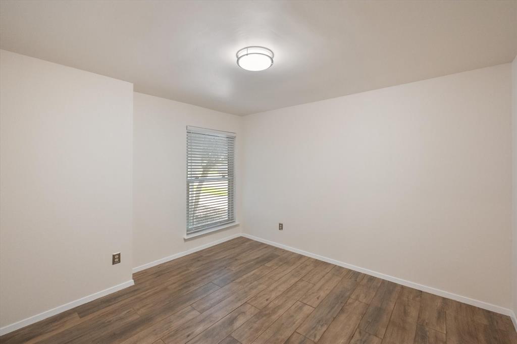1036 Clinton Street Carrollton, TX 75007 - Photo 29 of 40 Unfurnished room with baseboards and dark wood finished floors