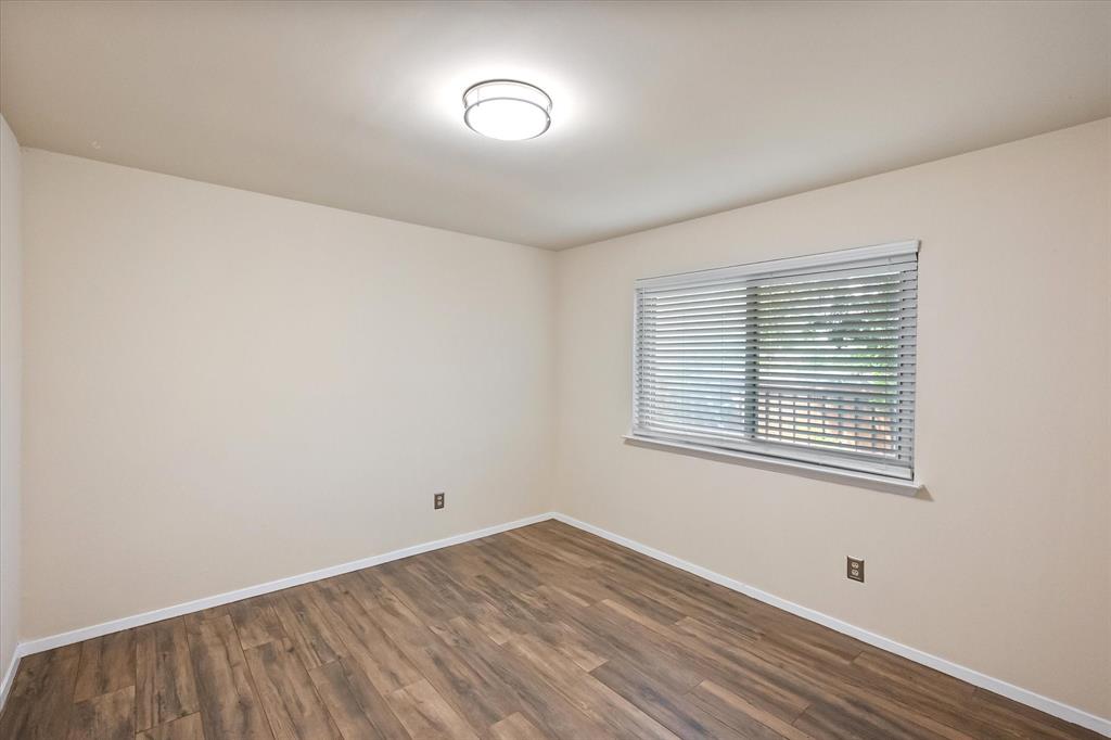 1036 Clinton Street Carrollton, TX 75007 - Photo 30 of 40 Spare room with dark wood finished floors and baseboards