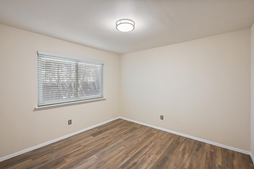 1036 Clinton Street Carrollton, TX 75007 - Photo 31 of 40 Spare room with baseboards and wood finished floors