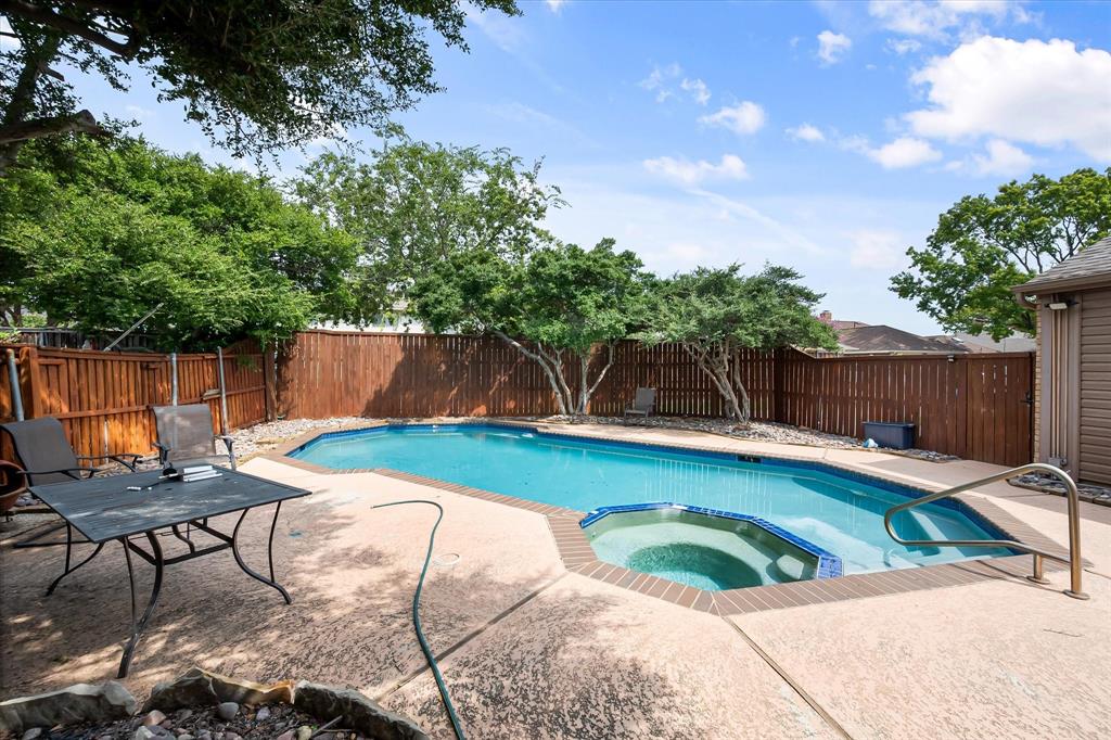 1036 Clinton Street Carrollton, TX 75007 - Photo 35 of 40 View of pool featuring a patio, a fenced backyard, and a pool with connected hot tub