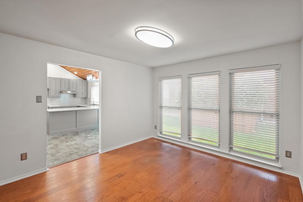 1036 Clinton Street Carrollton, TX 75007 - Photo 9 of 40 Spare room with light wood-style flooring and baseboards