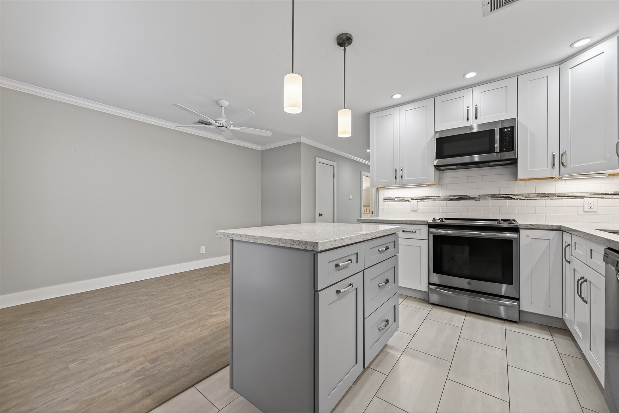 1805 Witte Road, Unit 3 Houston, TX 77080 - Photo 14 of 33 a kitchen with granite countertop a stove top oven a sink and a microwave