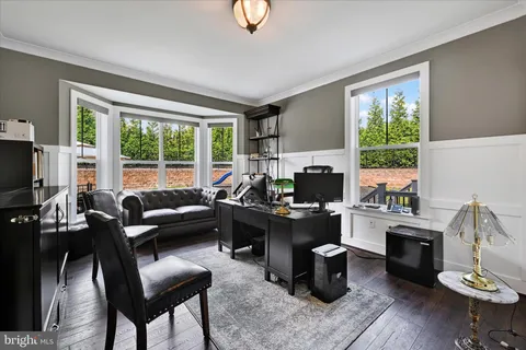 a open kitchen with stainless steel appliances granite countertop a stove top oven a sink dishwasher and white cabinets with wooden floor