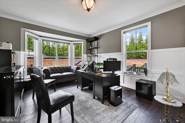 a open kitchen with stainless steel appliances granite countertop a stove top oven a sink dishwasher and white cabinets with wooden floor