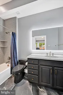 a dining room with furniture a chandelier and wooden floor
