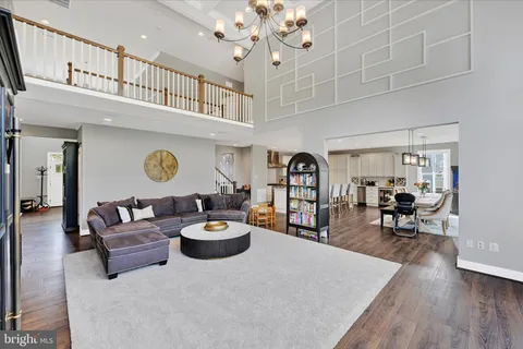 a dining hall with stainless steel appliances kitchen island granite countertop a dining table chairs and a kitchen view