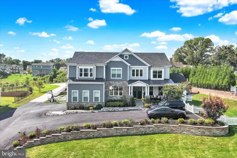 a view of a house with large windows and flower plants