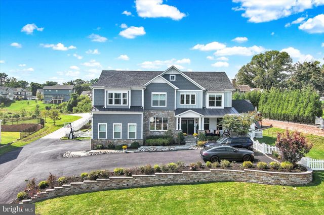 a view of a house with large windows and flower plants